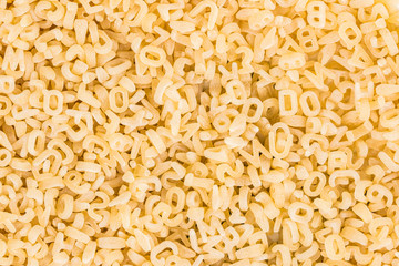 background of raw pasta in the form of letters and numbers