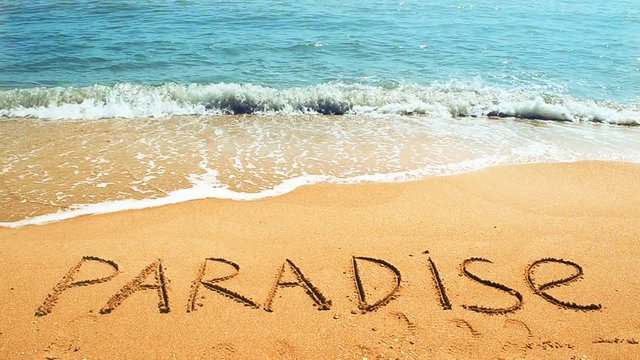 	Inscription paradise on sand.