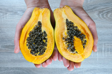 woman hands holding some papayas, sensual studio shot can be used as background