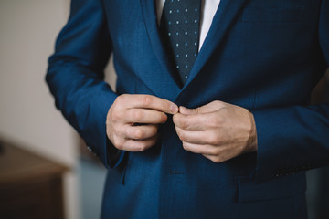 Dressing groom and preparing for ceremony