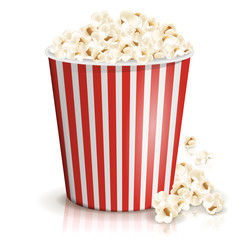 A full red-and-white striped bucket of fluffy popcorn isolated on the white background. Vector illustration. Popcorn fallen from cardboard or paper bucket. Cinema snack and movie food.