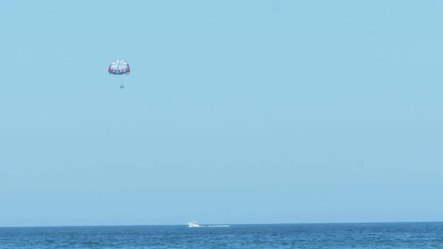 Parasailing From Boat in Ocean High Up