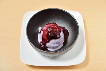 Blueberry ice cream in a black bowl