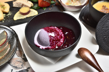 Blueberry ice cream in a black bowl