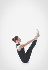Sporty young woman doing yoga practice isolated on white background - concept of healthy life