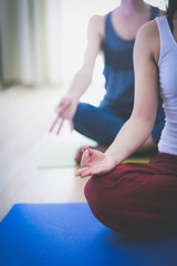 Naklejka premium Young healthy couple in yoga position on white background