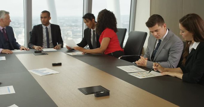 4k, Portrait of a bored mature businesswoman during a board room meeting. Slow motion.