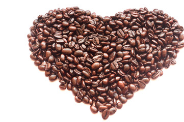 Roasted coffee beans in half heart shape on white background, isolated picture