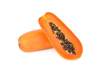 whole and half cut ripe papaya with seeds on white background