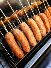 Thai sausage in Thai called Sai Krok Isan, made from mince pork, sticky rice, vermicelli. Mix all together, stuffed in pork chitterlings grilled on charcoal stove. Thailand street food.
