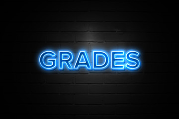 Grades neon Sign on brickwall