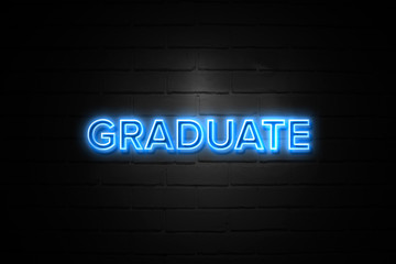 Graduate neon Sign on brickwall