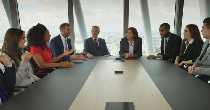 4k, A team of suit-clad business people having a heated debate in boardroom meeting. Slow motion.