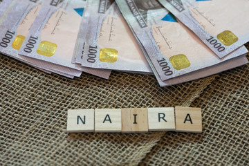 Nigerian Naira Notes with Letter Tiles Spelling