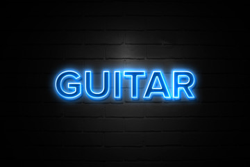 Guitar neon Sign on brickwall