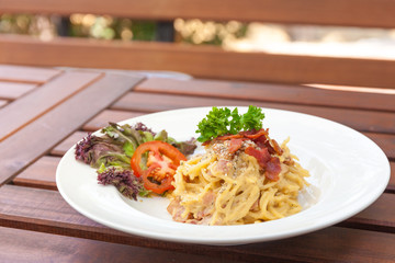 Spaghetti with bacon white cream sauce.