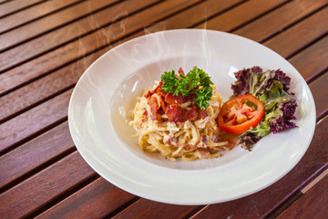 Spaghetti with bacon white cream sauce.