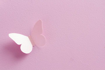 Paper butterflies on a pink background. Love and Valentine's day concept. Top view