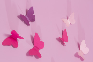 Naklejka na ściany i meble Paper butterflies on a pink background. Love and Valentine's day concept. Top view