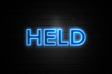 Held neon Sign on brickwall