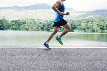 man runner jogger running at lake view in the morning