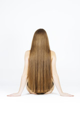 fashion studio photo of beautiful young woman with luxurious long hair, natural color, back view,...