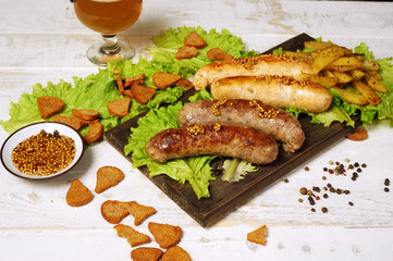 Meat fried sausages on a wooden table