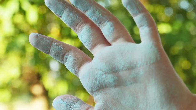 Child with Chalk Dust on Her Hands with Tree in Background, 4K