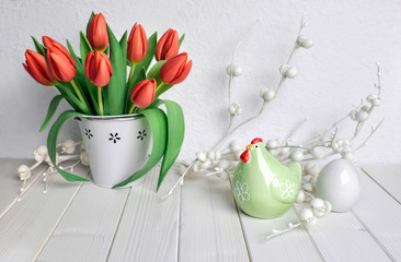 Easter greeting card design with bunch of red tulips, ceramic hen and egg on white
