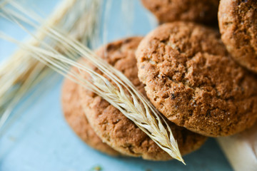 fresh oatmeal cookies in a bag made of paper on wooden background
