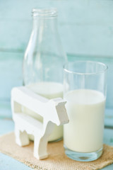 milk bottle, glass of milk, figure cow concept rustic food, fresh food on wooden.