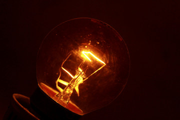 A bulb at night with bright lighted filament