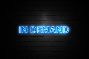 In Demand neon Sign on brickwall