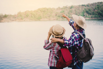 Asian girl and boy backpack in nature , Relax time on holiday concept travel,selective and soft focus,tone of hipster style