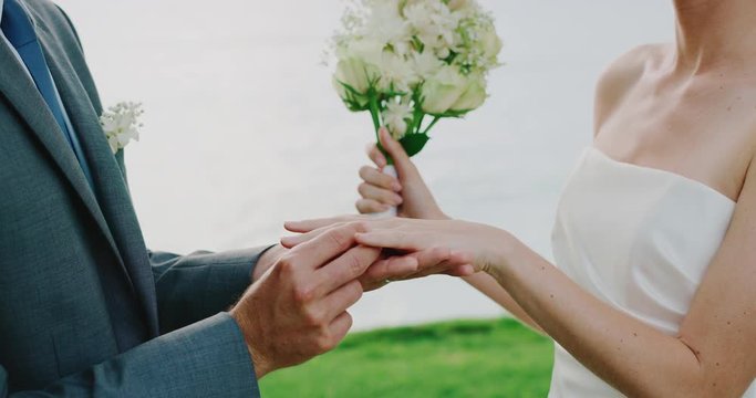 Bride and groom exchanging rings on wedding day