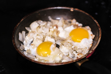 eggs are fried in a frying pan