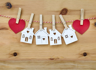 Hanging White Houses and Red Hearts on Wooden Background