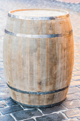 Obraz premium wooden barrel on pavement outdoors