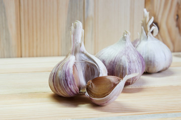 Garlic. Garlic Cloves and Garlic Bulb on a wooden background. Organic garlic. Selective focus. Close-up.