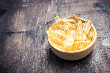 Fish oil capsules with omega 3 and vitamin D. healthy and diet concept.