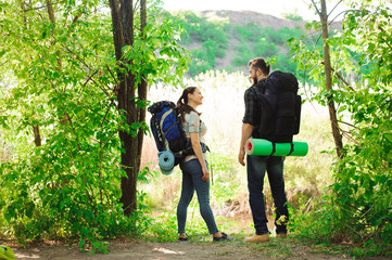 adventure, travel, tourism, hike and people concept - smiling couple with backpacks outdoors