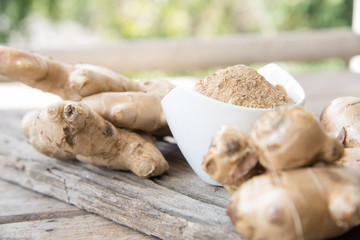 Fresh ginger on wood texture.
