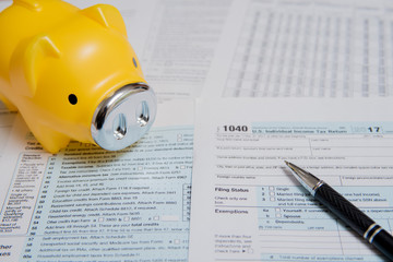 USA tax form 1040 with Piggy Bank and Pen