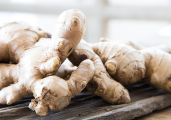 Fresh ginger on wood texture.