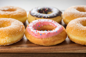 Many Flavors Donuts on Wooden Table.