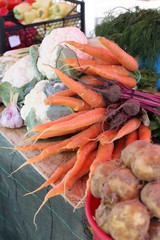 Local Farmers Market. Fresh produce: vegetables, berries, wild flowers. Older people buying groceries. Lithuania.