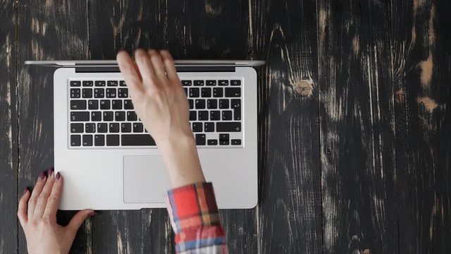 User hands placed a laptop on a grunge flat lay and start working