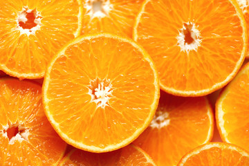 Fresh sliced orange fruit texture. Macro, top view, copy space. Food frame. Juicy oranges background