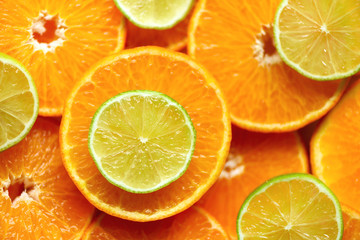 Fresh sliced orange fruit texture. Macro, top view, copy space. Food frame. Juicy oranges and lime background
