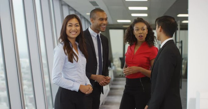 4K Cheerful business team in discussion in city office, businesswoman turns to smile to camera. Slow motion
